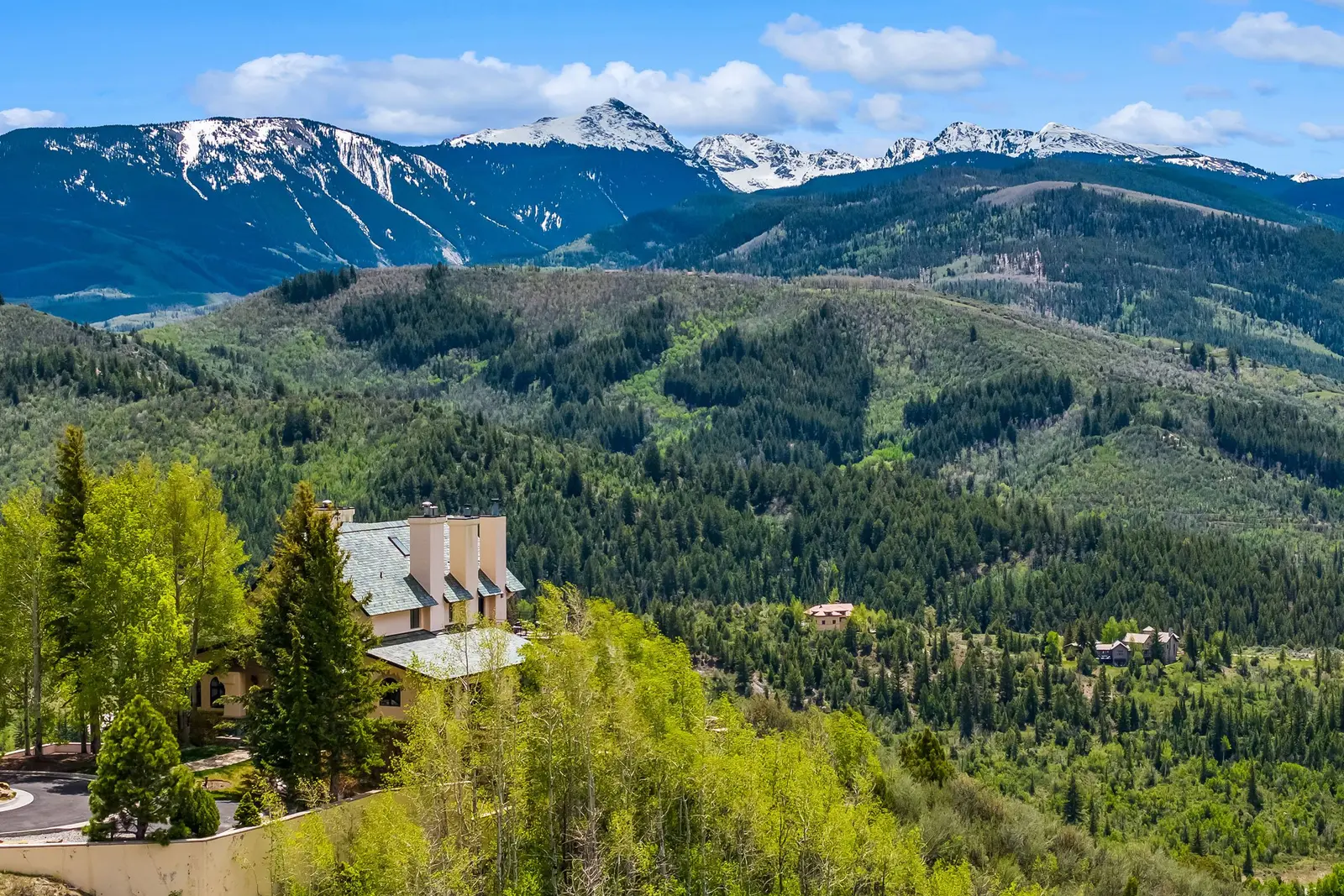 115 Alhambra Place: a mountain home on a forested ridge with snow-capped peaks beyond